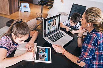 family using technology at table together